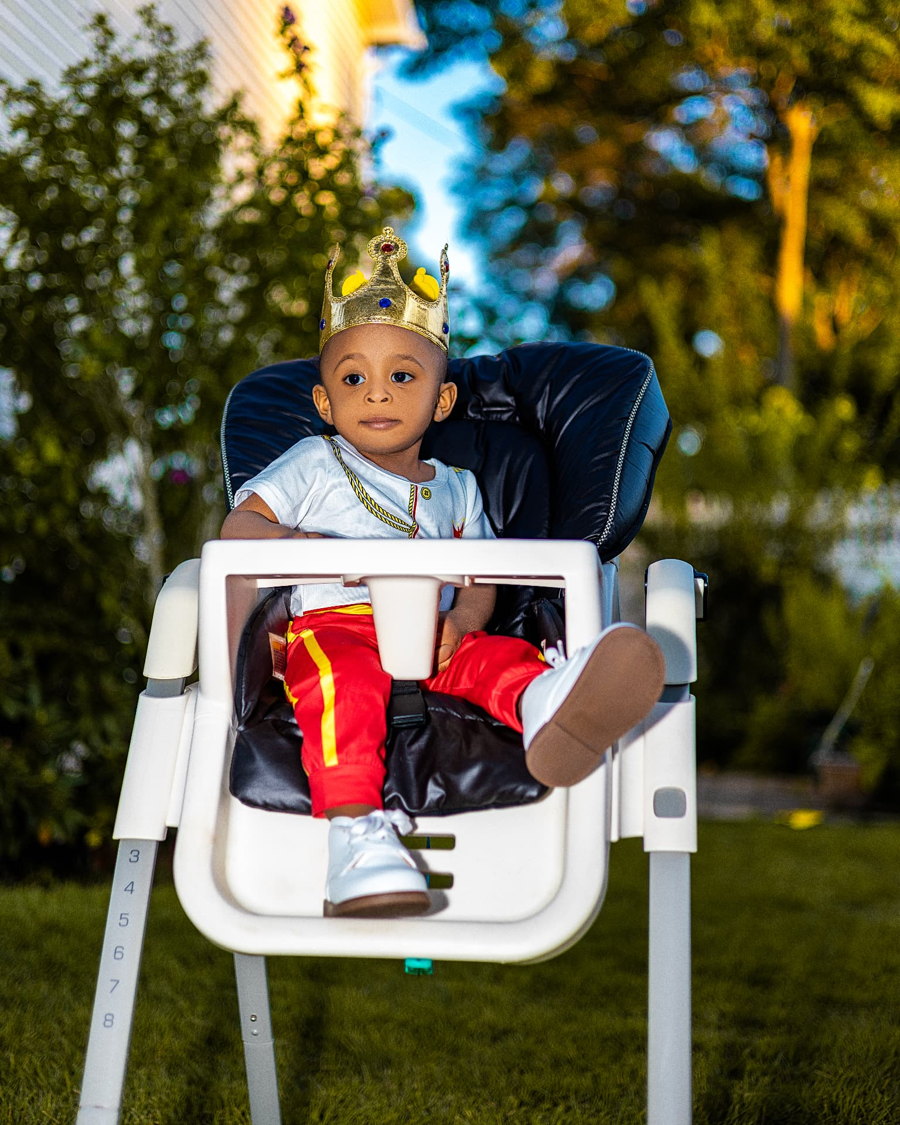 Birthday boy wearing a golden crown outdoors