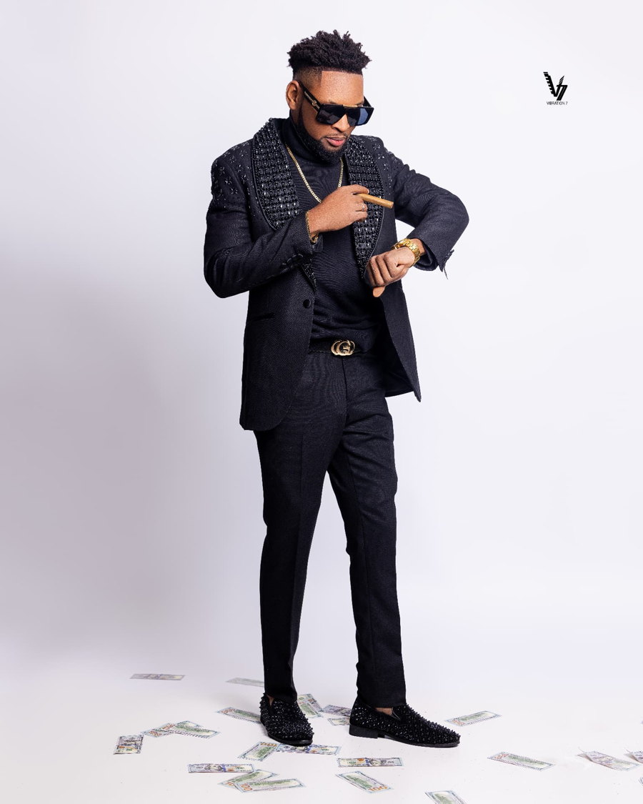 Studio portrait in a black suit and sunglasses