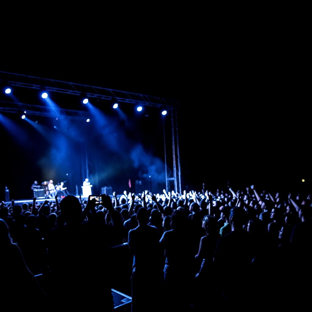 Live concert performance under blue stage lighting